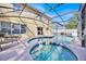 Relaxing pool, with spa, in screened enclosure offers a private retreat, in backyard at 16844 Rising Star Dr, Clermont, FL 34714