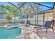 Backyard pool, spa with screened enclosure with patio furniture create a serene retreat at 16844 Rising Star Dr, Clermont, FL 34714