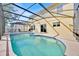 A stunning pool with spa and screened enclosure creates a backyard paradise, perfect for relaxation at 16844 Rising Star Dr, Clermont, FL 34714