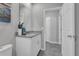 Well-lit bathroom featuring a granite vanity, contemporary fixtures, and ceramic tile flooring at 17309 Cagan Crossing Blvd, Clermont, FL 34714