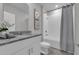 Bathroom with granite countertops, ample storage, and shower-tub combo for added convenience at 17309 Cagan Crossing Blvd, Clermont, FL 34714