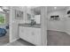 Bathroom featuring dual sinks, granite countertops and walk-in closet for storage convenience at 17309 Cagan Crossing Blvd, Clermont, FL 34714