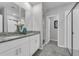 Bathroom boasts double sinks, granite countertops, and a glass-enclosed shower at 17309 Cagan Crossing Blvd, Clermont, FL 34714