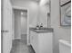 A sleek bathroom features a granite countertop, white cabinets, and tile floors at 17309 Cagan Crossing Blvd, Clermont, FL 34714