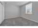 Empty bedroom with neutral carpet, a window, a closet, and freshly painted walls at 17309 Cagan Crossing Blvd, Clermont, FL 34714