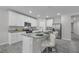 Modern kitchen with granite countertops, stainless steel appliances, a kitchen island with barstool seating and a breakfast bar at 17309 Cagan Crossing Blvd, Clermont, FL 34714