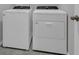 A bright laundry room features a white front-load washing machine and a dryer at 17309 Cagan Crossing Blvd, Clermont, FL 34714