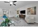 Comfortable living room features stylish furniture, a modern entertainment center, and inviting decor with a serene ambiance at 17309 Cagan Crossing Blvd, Clermont, FL 34714