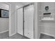 Modern all-white tile shower features frameless glass doors and integrated shelving at 17309 Cagan Crossing Blvd, Clermont, FL 34714