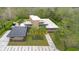 A captivating aerial perspective showcases a modern home with unique stone accents and solar panels at 1766 Alaqua Dr, Longwood, FL 32779