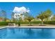 A serene backyard features a sparkling pool, palm trees, and a cozy bar area perfect for outdoor relaxation at 1766 Alaqua Dr, Longwood, FL 32779
