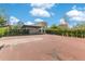 Backyard basketball court, surrounded by hedges, adjacent to the modern, stone home at 1766 Alaqua Dr, Longwood, FL 32779