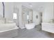 Bright bathroom featuring dual vanities, a freestanding tub, and modern fixtures for a spa-like experience at 1766 Alaqua Dr, Longwood, FL 32779