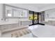 Elegant bathroom boasts double vanities, a soaking tub, and an expansive mirror creating a luxurious ambiance at 1766 Alaqua Dr, Longwood, FL 32779