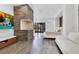 Bright bedroom features stone accent wall, flatscreen TV, and sleek flooring, creating a luxurious living space at 1766 Alaqua Dr, Longwood, FL 32779