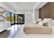 Modern bedroom with wood accent wall, platform bed, and sliding doors to pool and backyard at 1766 Alaqua Dr, Longwood, FL 32779