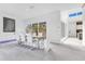 Modern dining room with large table and windows with tropical views at 1766 Alaqua Dr, Longwood, FL 32779