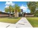 A modern home with stone accents, a lush green lawn, and a contemporary walkway at 1766 Alaqua Dr, Longwood, FL 32779