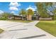 A modern home with stone accents, a lush green lawn, and a contemporary walkway at 1766 Alaqua Dr, Longwood, FL 32779