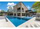 Wide shot of a luxury modern home with a stunning pool, stone accents, and multiple outdoor entertainment areas at 1766 Alaqua Dr, Longwood, FL 32779