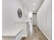Well-lit hallway with built-in storage, sleek flooring, and modern design elements for a seamless transition at 1766 Alaqua Dr, Longwood, FL 32779