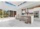 Bright modern kitchen with large island, stainless hood, brick backsplash, and lots of natural light at 1766 Alaqua Dr, Longwood, FL 32779