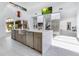 An open concept kitchen with stainless steel appliances, large island and a high ceiling at 1766 Alaqua Dr, Longwood, FL 32779