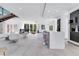 Bright open-plan living space with stairs, lots of natural light, and elegant, minimalist decor at 1766 Alaqua Dr, Longwood, FL 32779