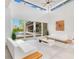 Spacious living room with soaring ceilings, modern decor, and access to the backyard pool at 1766 Alaqua Dr, Longwood, FL 32779