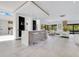 Open living space with a sleek bar, modern barstools, and clear view to the backyard at 1766 Alaqua Dr, Longwood, FL 32779