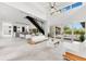 Expansive living area with modern staircase, stylish furnishings, and outdoor views of the pool and patio at 1766 Alaqua Dr, Longwood, FL 32779