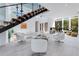 Bright open-plan living space with floating stairs, lots of natural light, and elegant, minimalist decor at 1766 Alaqua Dr, Longwood, FL 32779
