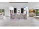 Entertaining space with bar and white bar stools and large windows at 1766 Alaqua Dr, Longwood, FL 32779