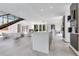 Bright open-plan living space with stairs, lots of natural light, and elegant, minimalist decor at 1766 Alaqua Dr, Longwood, FL 32779