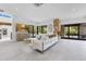 Spacious living room with comfortable white furniture, large windows, and a stone accent wall at 1766 Alaqua Dr, Longwood, FL 32779