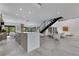 Open floor plan showcasing the bar, living room, fireplace, and black floating staircase at 1766 Alaqua Dr, Longwood, FL 32779