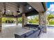 This covered outdoor area with stone accents offers a seamless transition to a pool and relaxing lounge seating at 1766 Alaqua Dr, Longwood, FL 32779