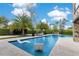 A backyard paradise with a sparkling pool, sun loungers, lush landscaping, and outdoor entertainment features at 1766 Alaqua Dr, Longwood, FL 32779