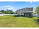 Spacious backyard featuring lush green grass, a two-story house and a privacy fence at 199 Boysenberry Ln, Daytona Beach, FL 32124
