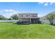 Open backyard featuring lush green grass, a two-story house and a privacy fence at 199 Boysenberry Ln, Daytona Beach, FL 32124