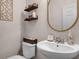 Stylish bathroom with a modern vanity, decorative mirror, and rustic shelving at 199 Boysenberry Ln, Daytona Beach, FL 32124
