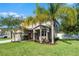 Beautiful home featuring well-manicured landscaping with palms and an attached two-car garage at 199 Boysenberry Ln, Daytona Beach, FL 32124
