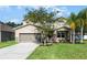 Charming two-story home featuring well-manicured landscaping and an attached two-car garage at 199 Boysenberry Ln, Daytona Beach, FL 32124