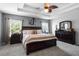 Spacious main bedroom with a large bed, tray ceiling, and matching nightstands at 199 Boysenberry Ln, Daytona Beach, FL 32124