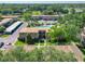 Aerial view of a well-maintained community with lush landscaping, mature trees, and a swimming pool at 200 Saint Andrews Blvd # 1004, Winter Park, FL 32792