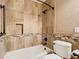A bathroom with decorative tile and an alcove in the shower and tub combination has an earthy, spa-like feel at 200 Saint Andrews Blvd # 1004, Winter Park, FL 32792