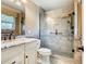A well-lit bathroom featuring a granite vanity, with a glass enclosed tiled shower that offers a spa-like experience at 200 Saint Andrews Blvd # 1004, Winter Park, FL 32792