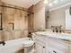 Bathroom with tub and shower combination, featuring decorative tile and neutral colored walls, alongside a modern vanity at 200 Saint Andrews Blvd # 1004, Winter Park, FL 32792