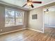 A sunlit bedroom features a ceiling fan, wood floors, and a mirrored closet, offering a blend of comfort and functionality at 200 Saint Andrews Blvd # 1004, Winter Park, FL 32792