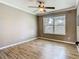Comfortable bedroom with wood-look floors and large window offering views of the community at 200 Saint Andrews Blvd # 1004, Winter Park, FL 32792